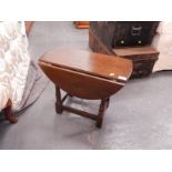 A small oak oval drop leaf coffee table.