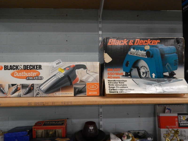 A Black and Decker electric circular saw, boxed, and a Black and Decker Dustbuster Auto, also boxed,