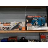 A Black and Decker electric circular saw, boxed, and a Black and Decker Dustbuster Auto, also boxed,