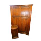 An Inglesants oak double wardrobe, with a pair of linen fold and carved panel doors, opening to