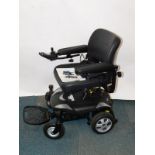 A Vietnamese made portable powerchair, with battery and user manual.