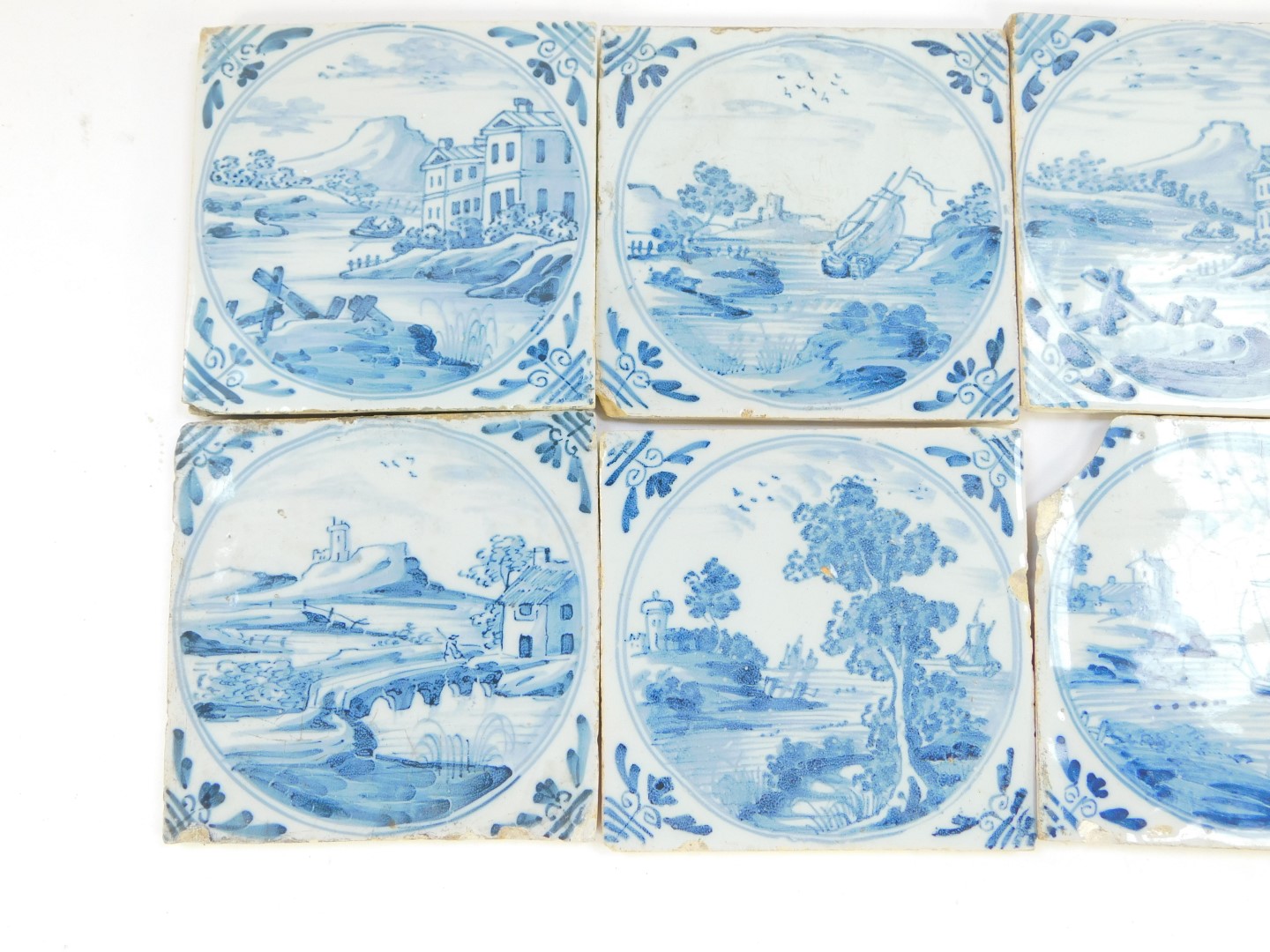 Eight 18thC Dutch delftware tiles, decorated with landscapes and riverscapes within circular - Image 2 of 4