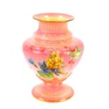 A late 19thC Royal Worcester porcelain vase, of fluted baluster form, painted with meadow flowers,