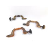 Three carpenter's button pad drill braces, one 19thC in brass and rosewood, signed W Kent,