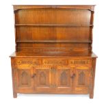 A Webber Croydon Range oak dresser, the two shelf plate rack over three carved drawers over four