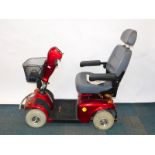 A FreeRider Mayfair red mobility scooter, model FR168-4, with battery and instructions.
