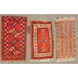 Three Caucasian prayer rugs, variously decorated, 72cm x 42cm, 79cm x 45cm, and 80cm x 45cm. (3)