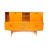 A G-Plan Fresco teak sideboard, with a pair of glazed central doors opening to reveal a lit single