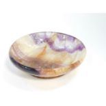 A Blue John circular dish, 14cm diameter. (AF)