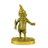 A Victorian brass novelty ink well modelled as Mr Punch, in standing pose, holding a quill and ink