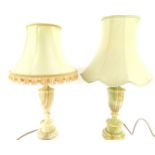 A near pair of green onyx table lamps, of Neo Classical urn form, with unmatched shades, 41cm high.