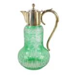 A late Victorian green glass claret jug, probably Stevens and Williams, engraved with blossom,