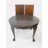 An Edwardian Chippendale style mahogany wind-out dining table, with two additional leaves, raised on
