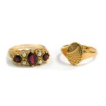 A 9ct gold and garnet three stone ring, set with pairs of seed pearls at intervals, size O/P,