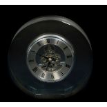 A Dartington crystal mantel clock, of circular form, silvered chapter ring bearing Roman numerals,