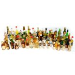 Miniature liqueurs, including gin, brandy, whisky, Creme de Cacal, Grand Marnier, and sherry. (