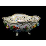 A 20thC Dresden porcelain bowl, of pierced form, encrusted and painted with flowers, raised on