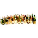 Miniature spirits and liqueurs, including whisky, Bacardi, Advocaat, Dubonnet and Cognac. (