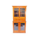 A Victorian oak bookcase, the outswept pediment above two doors, opening to reveal two shelves,