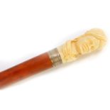 A Victorian malacca walking stick, with an ivory handle carved with an African gentleman, dated