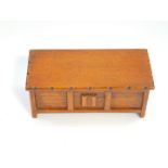 A Talent oak music box carved as a blanket chest, 8.5cm wide, 8.5cm deep.
