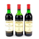 Two bottles of Baron Philippe De Rothschild Mouton-Cadet 1970, high and mid shoulder respectively,