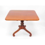 A Victorian mahogany tilt top breakfast table, the curved square top raised on a baluster turned