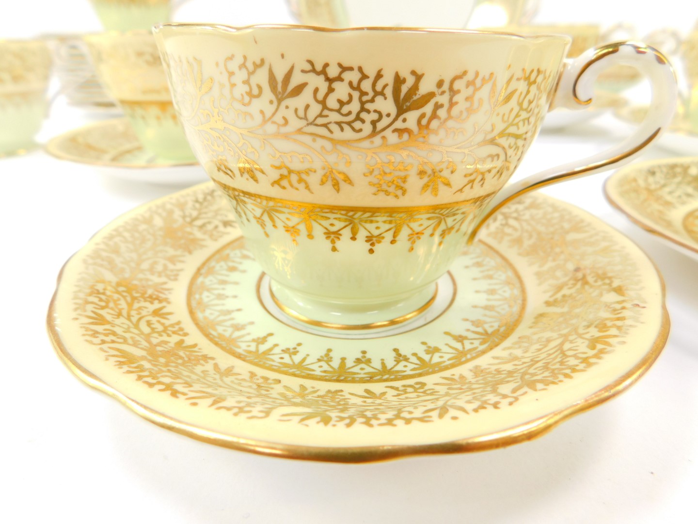 An Aynsley porcelain tea service, gilt decorated with mistletoe against a light green and peach - Image 2 of 3