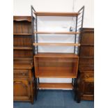 A Staples Ladderax shelving unit, with four variously sized shelves, and a two door glazed