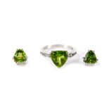 A silver Changbai peridot and white topaz ring, the triangular peridot claw set, with topaz set