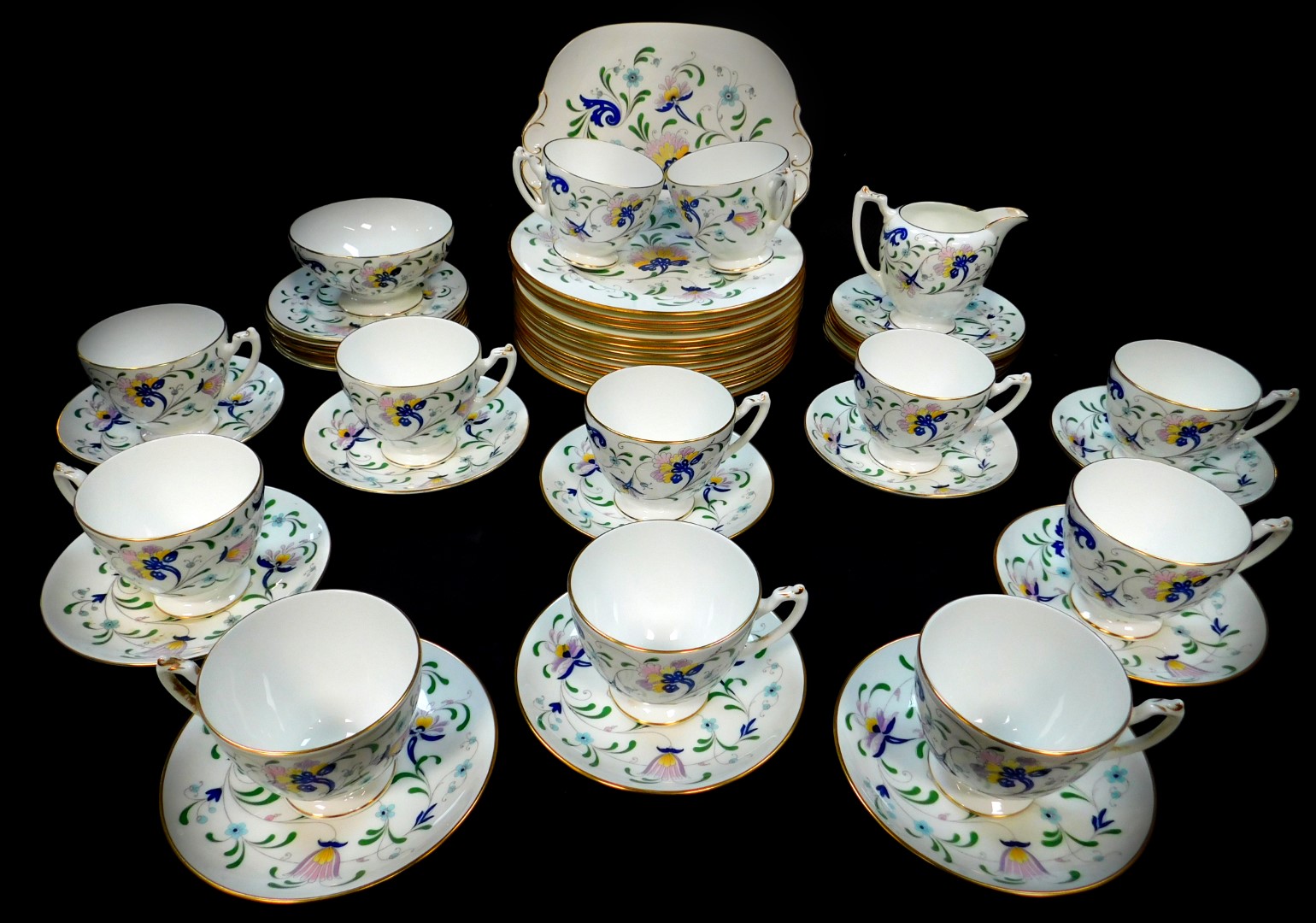 A Coalport porcelain tea service decorated in the Pageant pattern, comprising cream jug and sugar