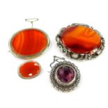 Three Victorian silver and agate brooches, together with a silver and amethyst brooch.