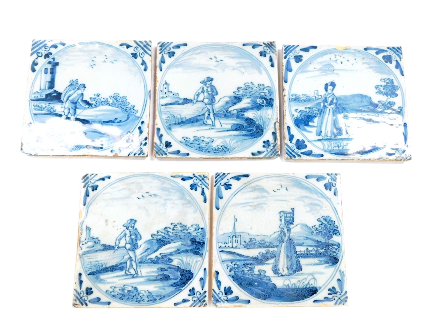 Five 18thC Dutch delftware tiles, decorated with men and women in rural settings, within circular