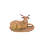 A cast iron door stop, cast as a recumbent buck deer, 22cm high, 37cm wide.