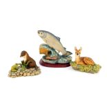 A Border Fine Arts sculpture of a leaping salmon, figure of a recumbent fawn, and an otter with
