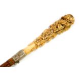 A Victorian lady's partridge wood walking cane, with an ivory handle carved with flowers and leaves,