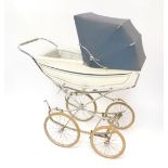 A Marmet coach built pram, with a blue trimmed white body, grey hood and blue floral interior