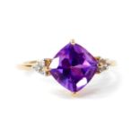 A 9ct gold amethyst and zircon ring, the cushion cut amethyst 2.02cts, size L/M, 1.87g gold, with