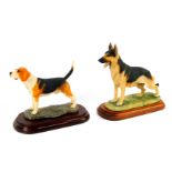 A Border Fine Arts sculpture modelled as a beagle, raised on an oval socle base, and another