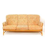 An Ercol ash studio couch, with foliate patterned cushions, 190cm wide.