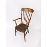A Victorian oak and elm gentleman's stick back kitchen chair, raised on turned legs united by an H