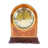 A French walnut cased thirty hour mantel clock, with circular brass dial bearing Roman numerals,