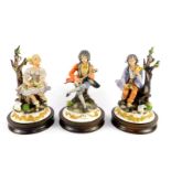 Three Capodimonte porcelain figures, modeled by Sartori, raised on wooden socle bases, comprising