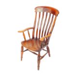 A Victorian oak and elm lath back kitchen chair, raised on turned legs united by an H frame