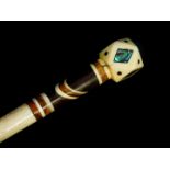 A 19thC whale bone and baleen inlaid walking cane, the faceted rhomboid handle with mother of