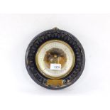 An Edwardian ebonised circular wall barometer, with engraved plate 'Presented by Portsmouth Model