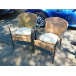 A pair of tubular metal and plastic rattan garden tub chairs, with cushions.