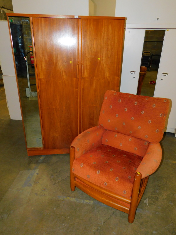 An Ercol style elm framed armchair upholstered in patterned red fabric, together with an Austinsuite