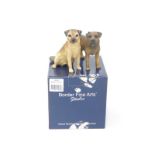 Two Border Fine Arts figures modelled as border terriers, one standing, one seated, with one box.