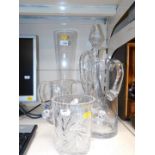 A cut glass claret jug, two further jugs, a tall vase and a cut glass ice bucket. (5)